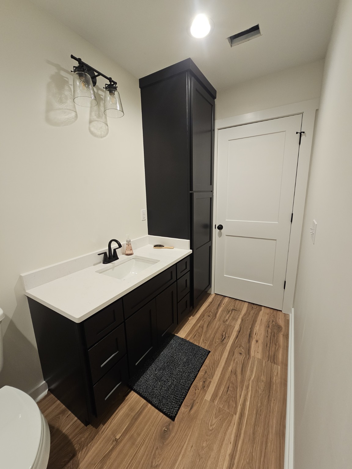 Vanity and full-height storage by Hilltop Cabinets LLC